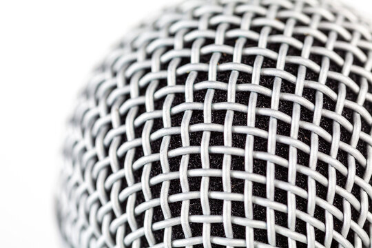 Macro closeup detail of a silver microphone grille structure with woven metal mesh, abstract background texture for studio audio recording and podcast studio themes, voice music production backdrop