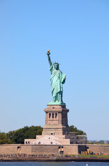 Fototapeta premium statue of liberty with torch in hand raised arm symbol of liberty democracy new york usa