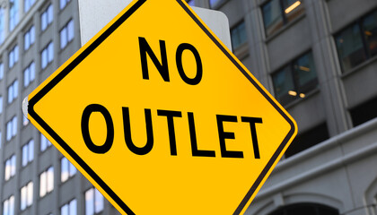 yellow street sign with the text NO OUTLET on a road