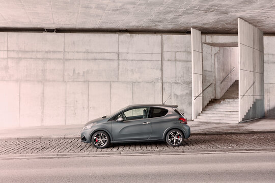 Grey Peugeot 208 GTI with original matt varnish standing under the concrete wall. Cult hot hatch, fast and agile. Engine 1.6l, 208 hp, 6.5s 0-100km Katowice, Poland-05.05.2016