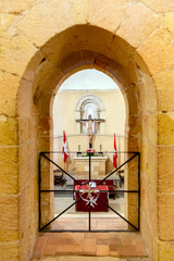 Ancient Templar church interior in Segovia, Spain. The nave features towering stone columns and...