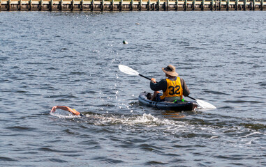 Kayak Assists Swimmer in Bay Waters During a Swim Across The Bay Event