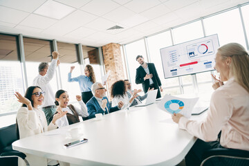 Fototapeta premium Dynamic team collaboration during a professional business presentation in a modern office space