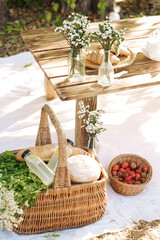 Summer picnic with fresh bread, lemonade and strawberries