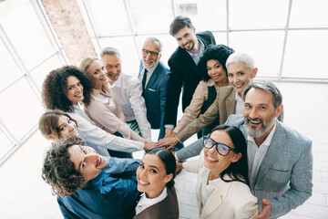 Multi-ethnic team of professionals collaborating in modern office space, emphasizing teamwork,...