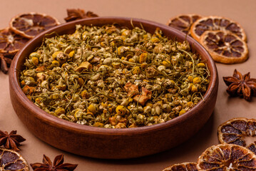 Dried chamomile flowers, herbal tea in a bowl for a hot morning drink. Dried chamomile