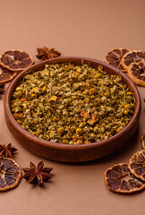 Dried chamomile flowers, herbal tea in a bowl for a hot morning drink. Dried chamomile