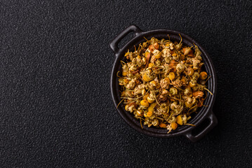 Dried chamomile flowers, herbal tea in a bowl for a hot morning drink. Dried chamomile