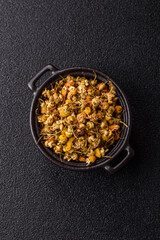 Dried chamomile flowers, herbal tea in a bowl for a hot morning drink. Dried chamomile