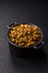 Dried chamomile flowers, herbal tea in a bowl for a hot morning drink. Dried chamomile