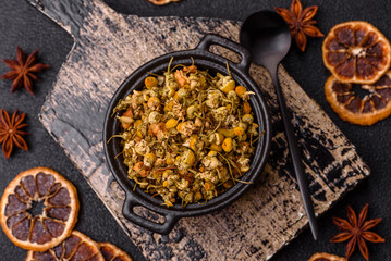 Dried chamomile flowers, herbal tea in a bowl for a hot morning drink. Dried chamomile