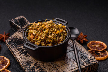 Dried chamomile flowers, herbal tea in a bowl for a hot morning drink. Dried chamomile