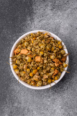 Dried chamomile flowers, herbal tea in a bowl for a hot morning drink. Dried chamomile