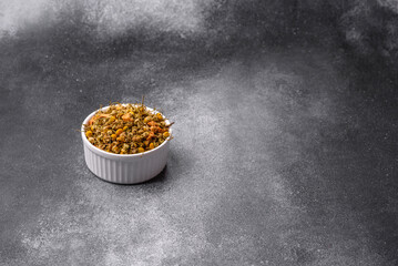 Dried chamomile flowers, herbal tea in a bowl for a hot morning drink. Dried chamomile