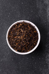 Golden black tea, dried leaves of a Chinese or Indian breakfast drink. Black tea dried leaves