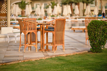 Bar chairs, circle table and blurred background in a hotel. Outdoor. Shallow depth of field.