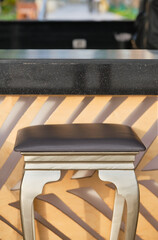 Bar counter with bar stool against blurred background. Outdoor. Shallow depth of field.