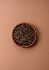 Golden black tea, dried leaves of a Chinese or Indian breakfast drink. Black tea dried leaves