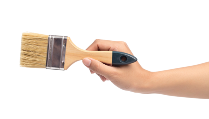 Hand holding a paintbrush