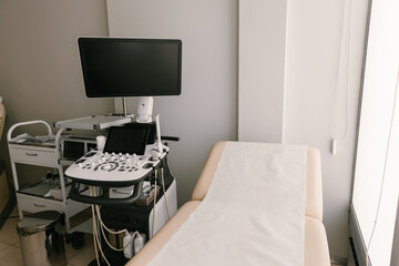 Interior of gynecology clinic with ultrasound monitor and medical equipment