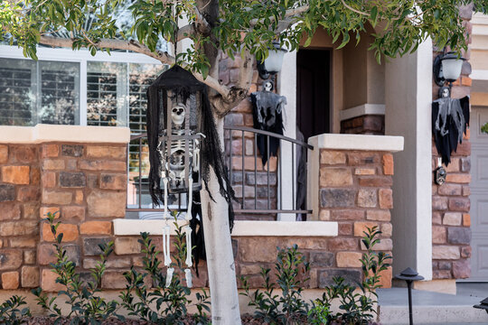 Skeleton decor in autumn time for Halloween celebration in front of the house