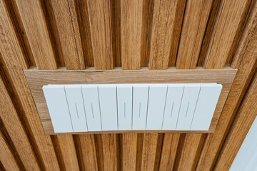 The modern ceiling design features elegant wooden panels coupled with an easytouse switch control, allowing for both aesthetic appeal and functional lighting adjustments in contemporary spaces