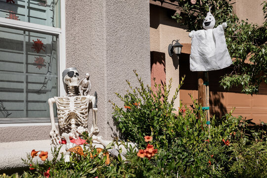 Fall and Halloween decoration adorn a haunted house front yard