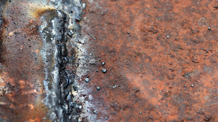 old iron sheet. Rusty metal surface and crooked welds. Rusty steel. vintage style. rusty iron. for background. close-up. oxidation, destruction. worn surface. space for text. close-up, macro