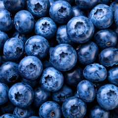 Close-up photograph of a pile of fresh, ripe blueberries