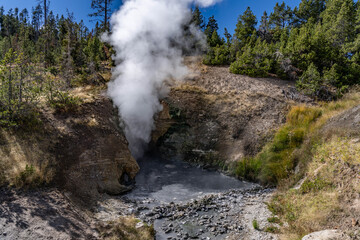 Dragon's Mouth Spring, Mud Volcano area,  Yellowstone National Park, Wyoming. A mud volcano or mud dome is a landform created by the eruption of mud or slurries, water and gases


