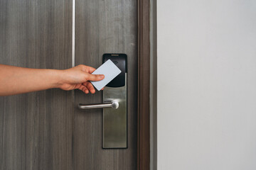 Electronic card key for open door in hotel. Smart card key to lock and unlock door. Security systems and protection concept.