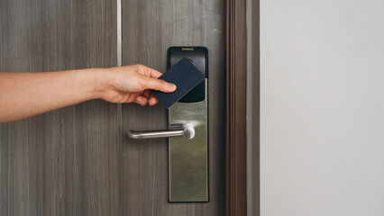 Electronic card key for open door in hotel. Smart card key to lock and unlock door. Security systems and protection concept.