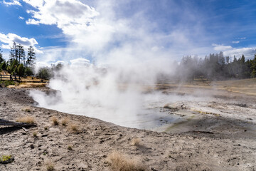 Churning Caldron. Mud Volcano area, Yellowstone National Park, Wyoming. A mud volcano or mud dome is a landform created by the eruption of mud or slurries, water and gases