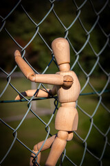 Outdoor photos of a wooden art manequin for sketching human body