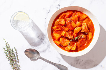meat goulash with potatoes and carrots, sweet peppers, in a saucepan, top view, traditional Hungarian soup, homemade, no people,