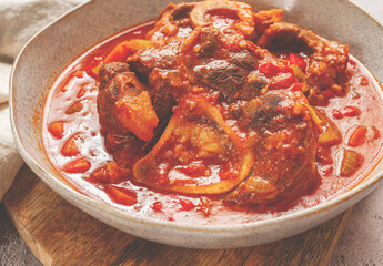 ossobuco, stewed meat knuckle on the bone, with oats and spices, homemade, no people,