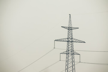 High Voltage Poles or Electric tower is transmission high voltage power locate on green field - Energy technology concept