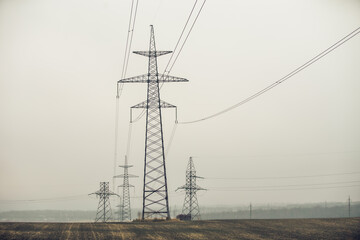 High Voltage Poles or Electric tower is transmission high voltage power locate on green field - Energy technology concept