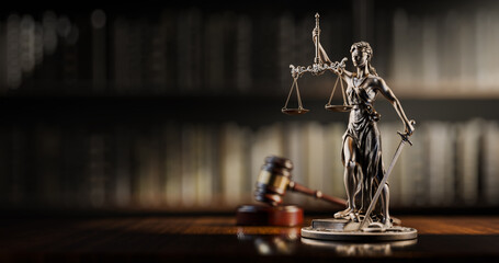 Legal Concept: Themis is the goddess of justice and the judge's gavel hammer as a symbol of law and order on the background of books