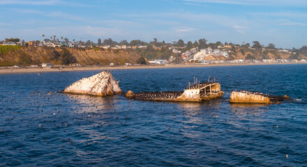 The SS Palo Alto wreck lies off Seacliff State Beach, with its hull protruding above calm waters....