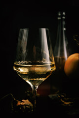 Close-up of white wine in glass with warm light reflections and subtle autumn background