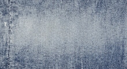 Close up of blue denim fabric with a lighter wash in the center.