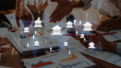 A dynamic business meeting showcasing hands engaged in discussion over charts and graphs,...