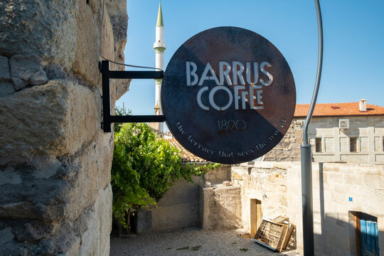 Barrus Coffee offers a serene spot to enjoy drinks in a historic stone courtyard under a clear sky. Ortahisar, T&uuml;rkiye - August 11, 2025