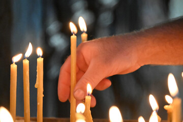 candles in the hands of the man