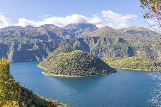 Cotacachi, Ecuador &ndash; August 5, 2025: Cuicocha Lagoon in the Ecuadorian Andes, surrounded by vegetation. In the background, the majestic Cotacachi Volcano with its summit hidden among the clouds.