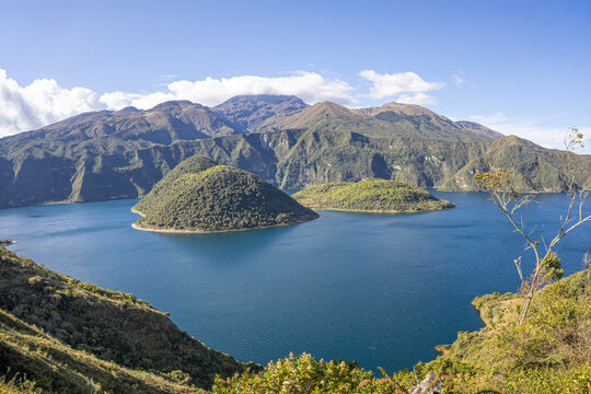 Cotacachi, Ecuador &ndash; August 5, 2025: Cuicocha Lagoon in the Ecuadorian Andes, surrounded by vegetation. In the background, the majestic Cotacachi Volcano with its summit hidden among the clouds.