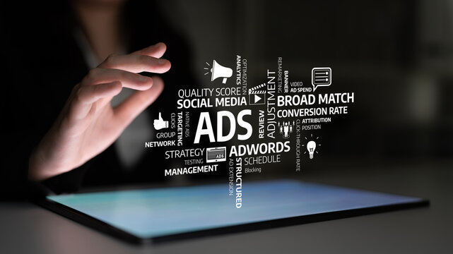 A businessperson engages with a digital representation of marketing concepts on a touchscreen tablet, illuminating strategies for effective online advertising. Tessel