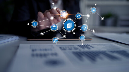 A professional workspace showcases digital transformation with technology icons overlaid as a hand interacts with a tablet, symbolizing innovation and connection in business. Tessel