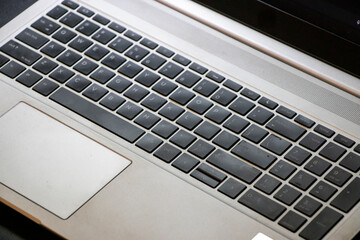 Close-up view of a laptop keyboard showcasing individual keys and touchpad. Ideal for tech-related materials, office environments, or educational content.